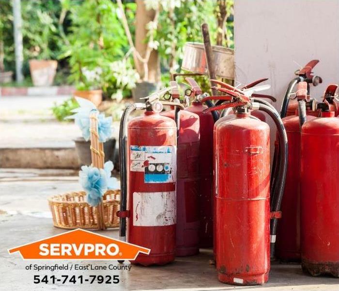 A group of fire extinguishers is seen.