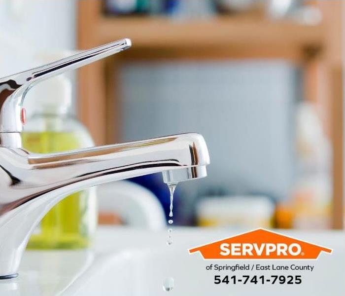 A trickling faucet is shown in a bathroom.