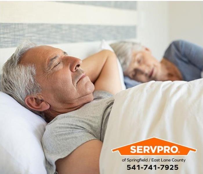 An elderly couple is sleeping peacefully.