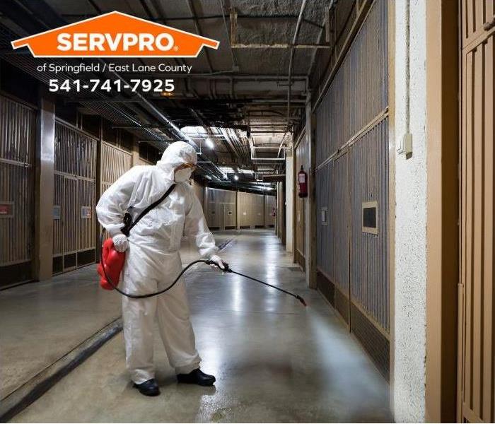 A technician decontaminates a building.